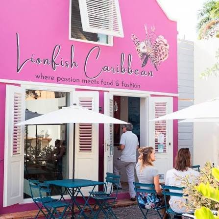 Pink Lionfish Caribbean storefront with outdoor tables in Aruba